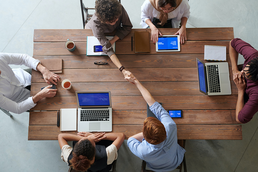 Small Agency Meeting with Clients at a table. 